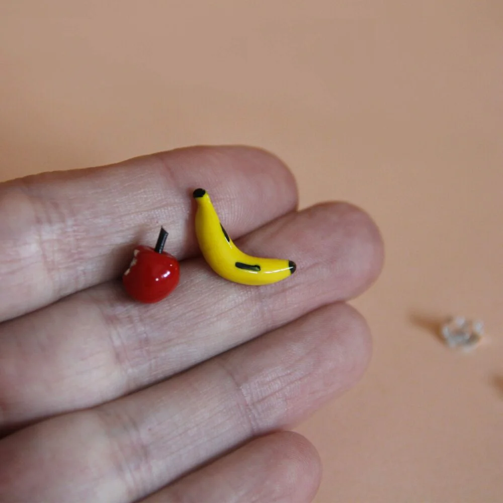 Silver different earrings, apple and banana